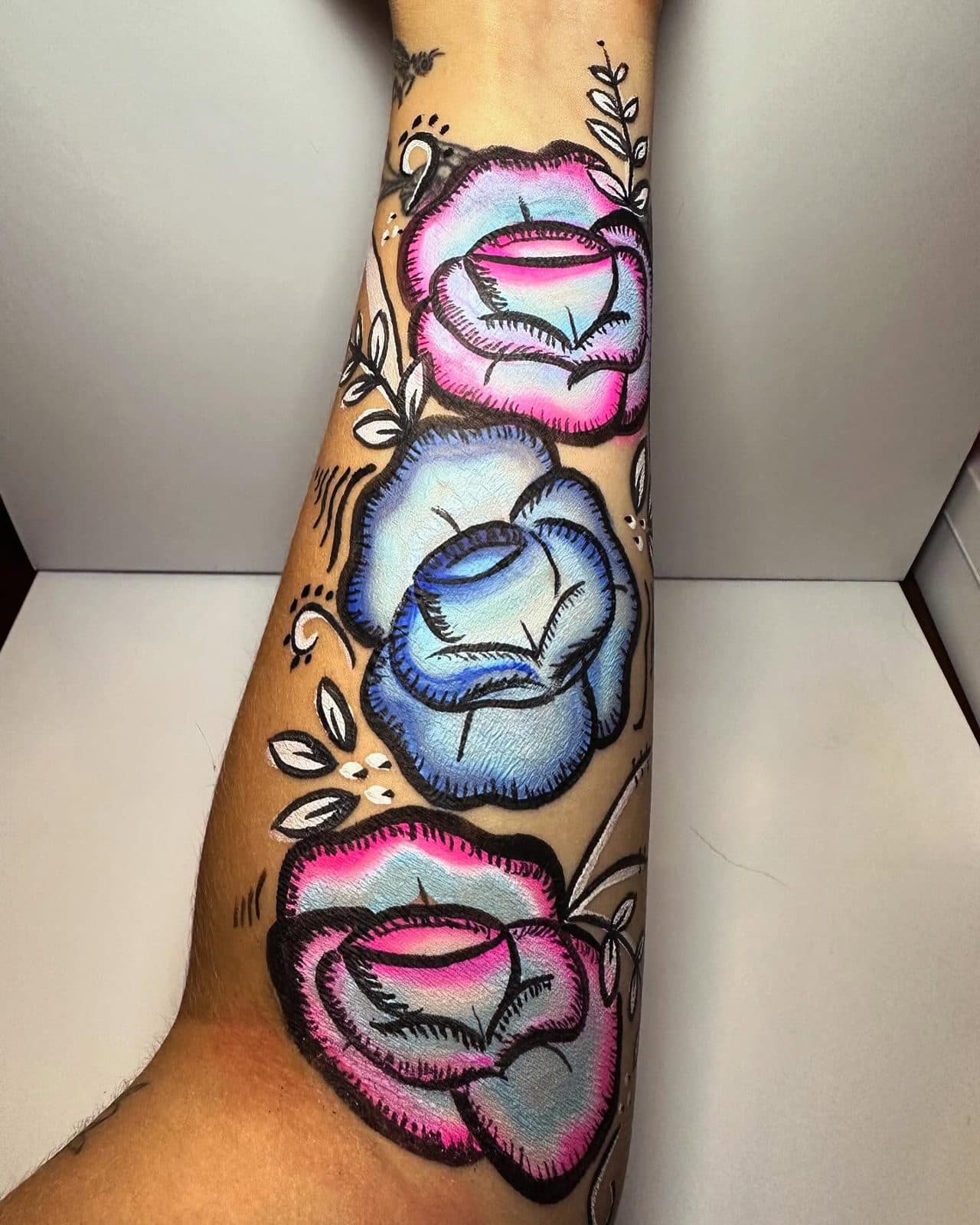 Painted roses on an arm