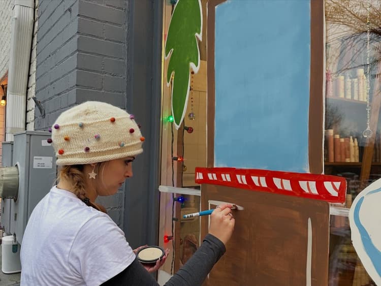 Brier painting a storefront window